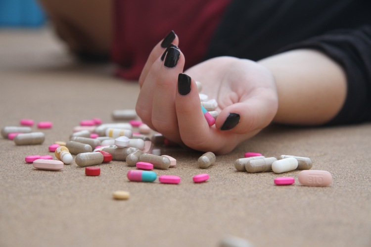 Girl took too much medicine and is lying on the floor