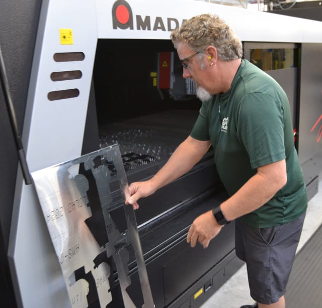 Unloading an AMADA liber laser CNC machine at the Fleet Readiness Center Southeast.